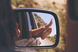 Feet relaxing out a car window
