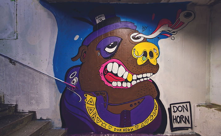 Clean comic character graffiti PIMP DAWG in underpass