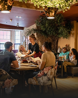 Group dining in a cozy London restaurant with modern decor
