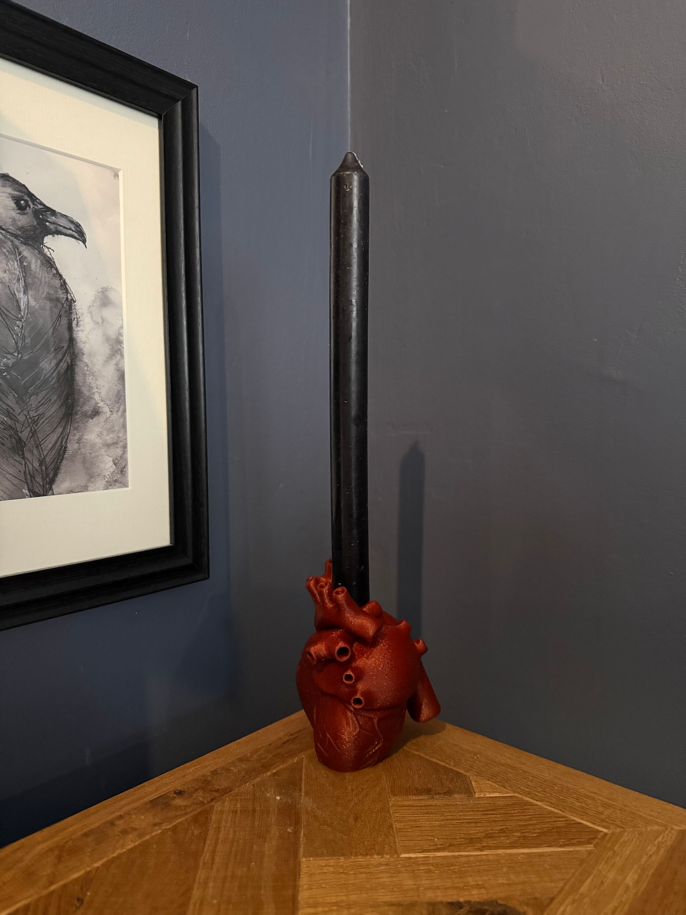 Thumbnail: an anatomical heart tapered candle holder in shimering red
