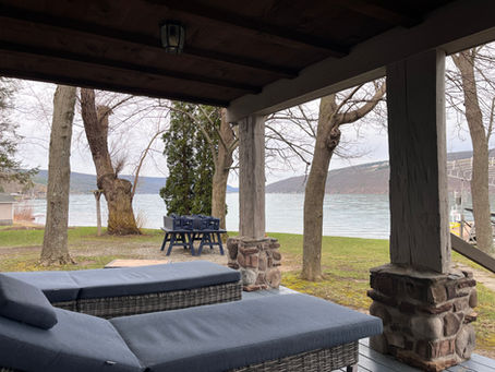 Eye-level view of a serene lake at dawn with soft pastel colors