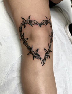 Tattoos for women of a heart in black and gray