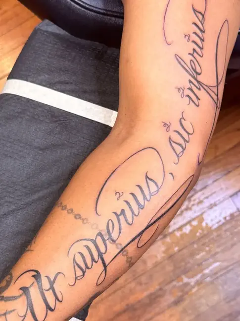 Large memorial script tattoo on forearm with elegant cursive lettering in Fort Worth