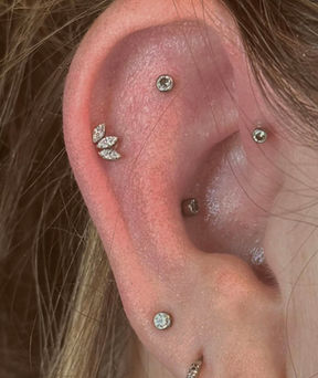 tragus, daith and ear lobe piercing with beautiful diamond jewelry by our Fort Worth Piercing shop