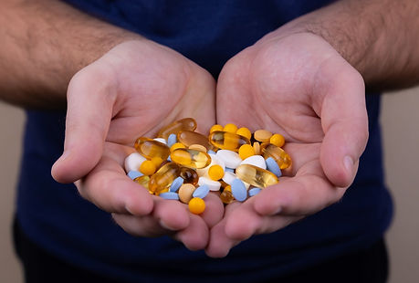 Group of pills held by two open hands