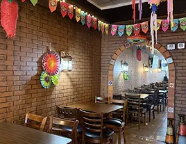 Cozy brick-wall dining room at Auténtica Taqu