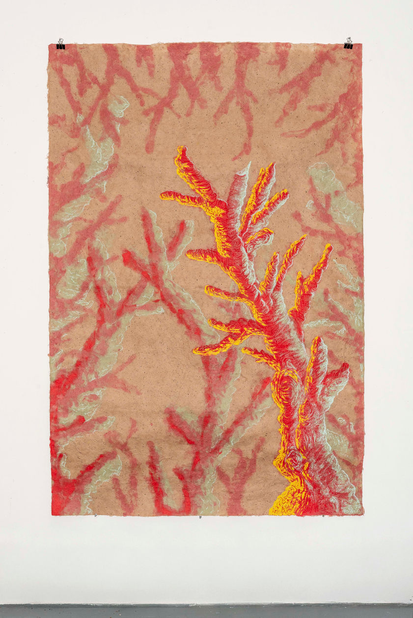 Paper pulp gathers in water like memory before it becomes form. Mulberry fibers drift and tangle, pale and tensile, carrying a quiet strength. Pigment seeps into the mixture, not sitting on the surface but entering the body of the sheet itself. The image is formed from within—like history—embedded rather than illustrated.

As the pulp settles into the mold, landscapes begin to surface. Hints of hills rise through thicker deposits of fiber; lighter washes dissolve into sky. Colors recall sunburned earth, olive leaves, sea light, dust after wind. The material holds the sensation of heat and dryness, of walking barefoot on soil, of shade gathered beneath a tree. Childhood appears not as a fixed narrative but as atmosphere: the echo of voices carried across an open field, the geometry of stone houses, the rhythm of seasons shifting from green to gold.

The fibers intertwine like roots beneath the ground, binding fragments of personal and collective memory. Mulberry becomes both fragile and resilient, much like the act of remembering itself. The surface buckles and rises in subtle relief, suggesting terrain shaped by time—valleys of absence, ridges of presence. Pigment pools in certain areas, staining them more deeply, like moments that refuse to fade.

In these pulp paintings, nature and childhood history are inseparable. The land is not a backdrop but a participant—absorbing stories, holding traces of movement, carrying both tenderness and tension. The sheet becomes a field where past and present coexist, where fiber and soil, memory and landscape, merge into one quiet, breathing surface.