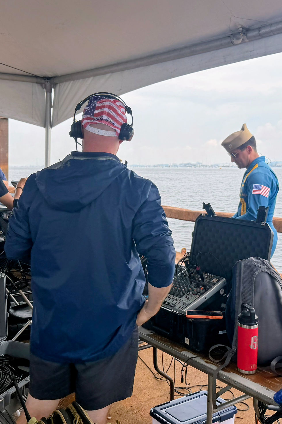 Airshow announcer wearing headphones at a sound mixing board