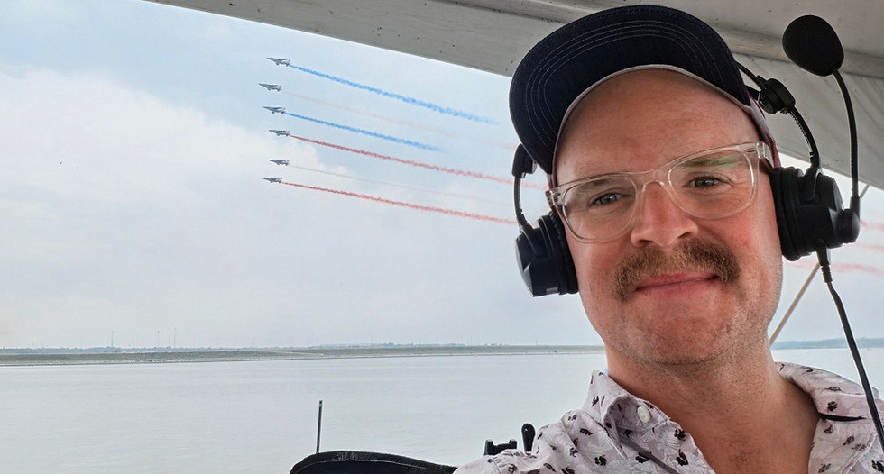 Airshow announcer with headset as jets fly in formation