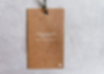 An eco-friendly tag made of recycled paper, showcasing its natural colour and texture.