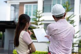Homebuyer with man in hardhat during a home inspection