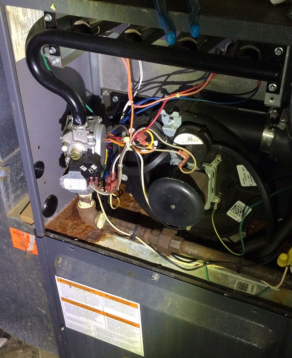 Close-up view of a residential HVAC heating system and mechanical components during a home inspection.