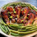 Drumsticks on a serving platter with green beans. 