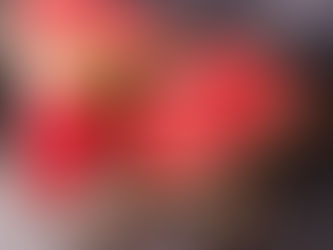 A glass of watermelon aqua fresca on a table with watermelon slices.