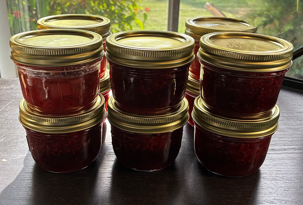 High angle view of jars filled with assorted fruit jam on a wooden table