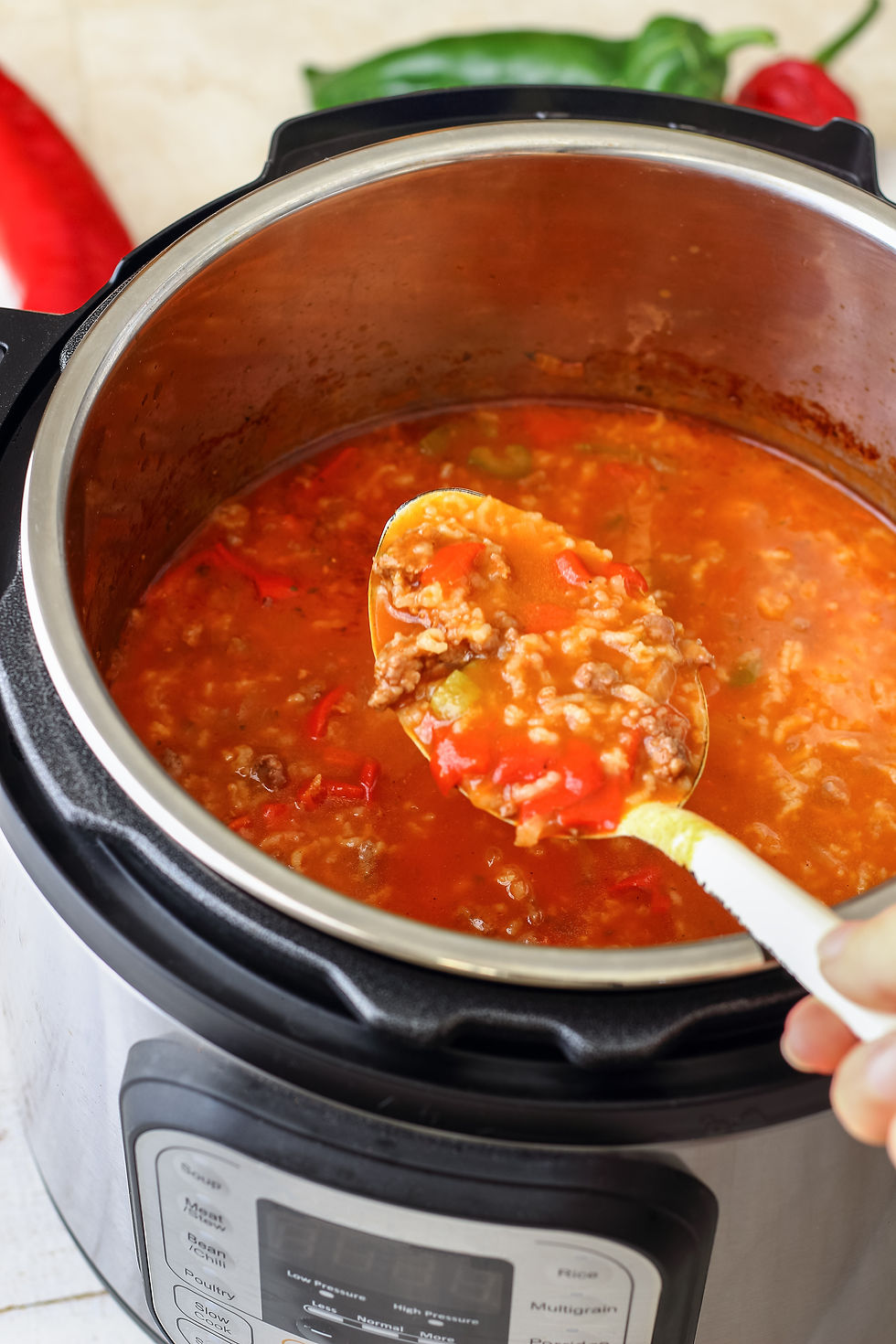 Eye-level view of a large bowl of spaghetti Bolognese topped with Parmesan cheese