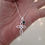 Thumbnail: Sterling silver Cross 25 mm long with emerald bezel charm.