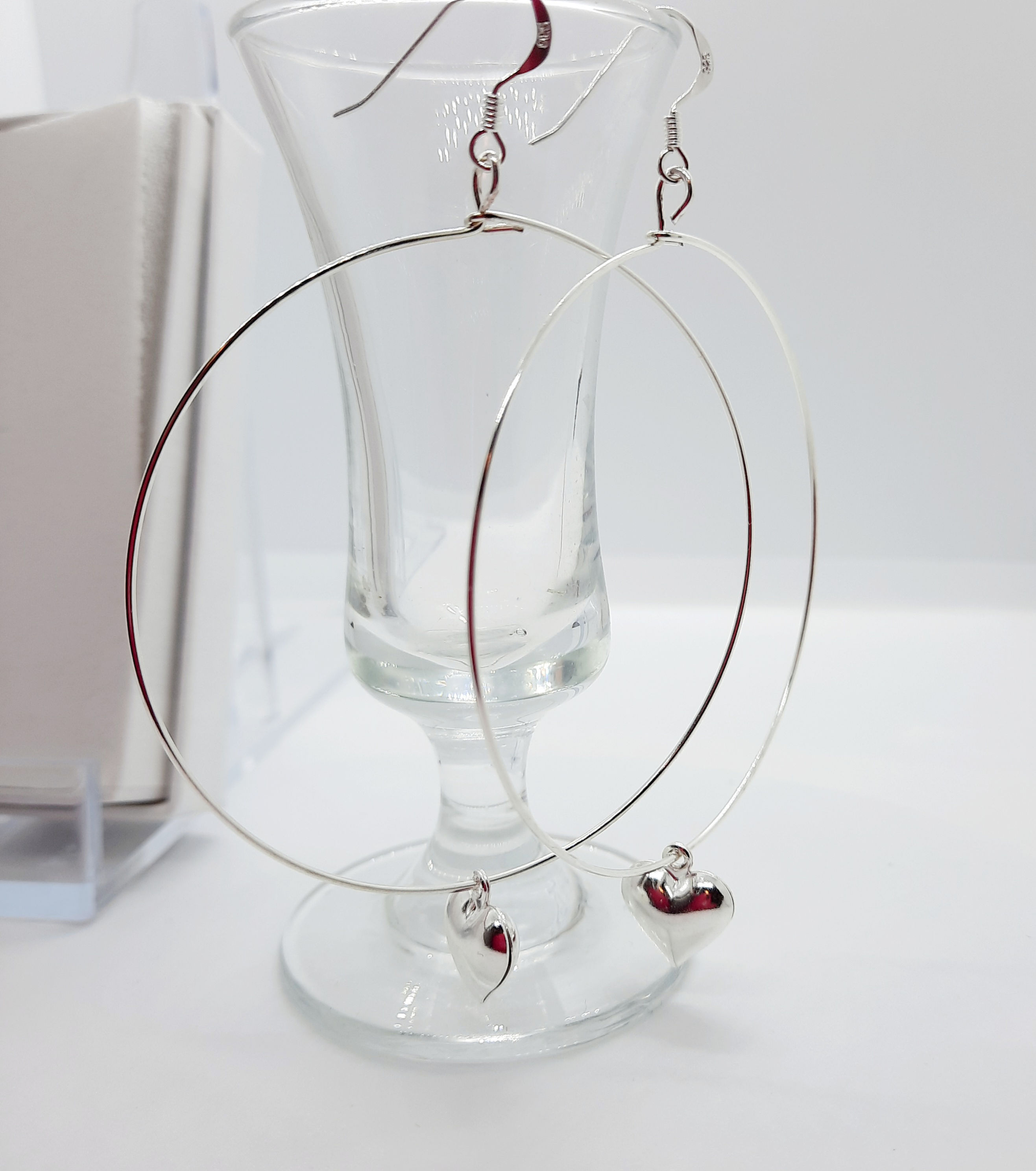 Large hoops with silver colour heart on sterling silver ear hooks.