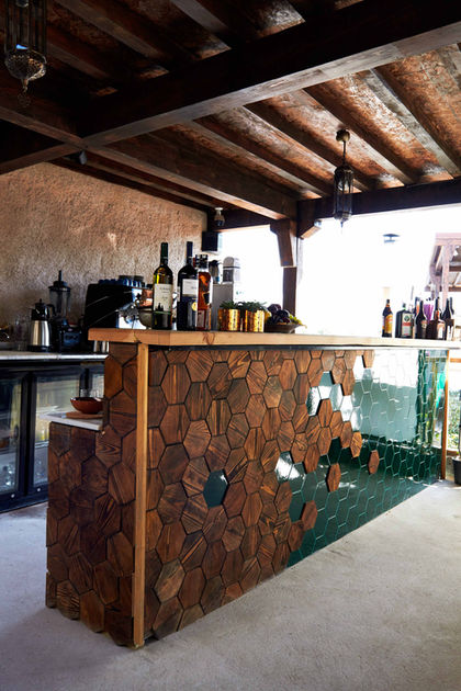 Wooden bar with bottles, glasses, and decor with a rustic interior setting