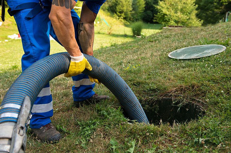 Man pumping out a septic tank
