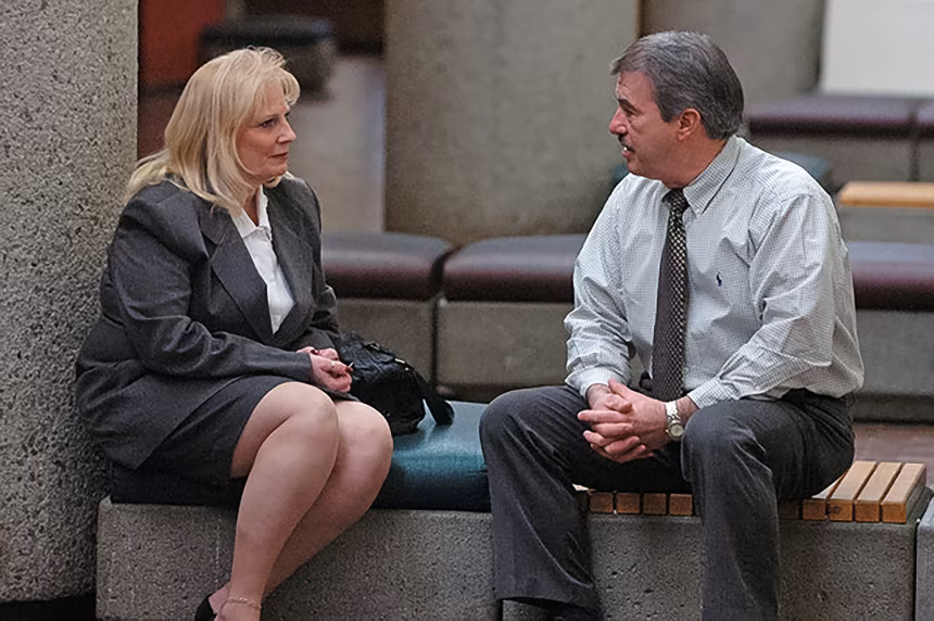 May Martinez sits with retired Knoxville Police Detective Randy York outside a courtroom in Knox County on Feb. 27, 2006.