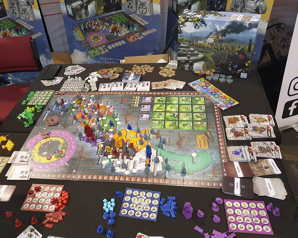 A game of Daimyo set up in play on a table with the box stood upright in the background. The board features a map of Japan. Airecon Stone Sword Games Daimyo - Katenic - March 2023