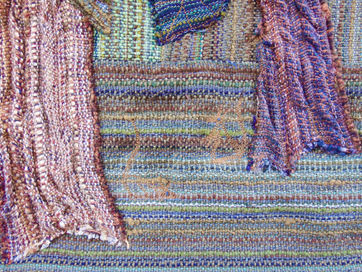 Multicolored woven fabric with fringe hanging down.