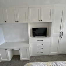 bespoke bedroom suite which includes a wardrobe, dressing table, media storage, dresser and overhead cupboards.