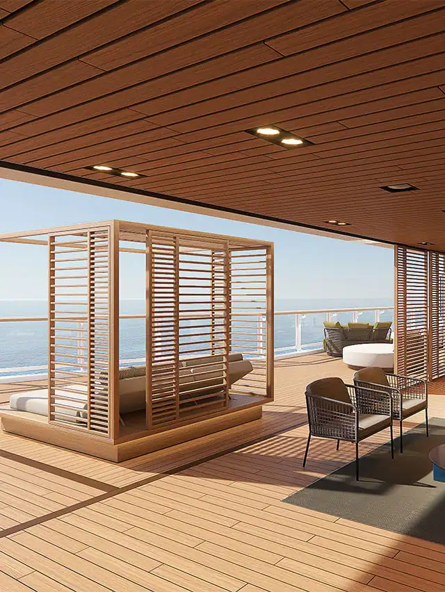 An outdoor seating area with views of the ocean. The decor is natural and wooden.
