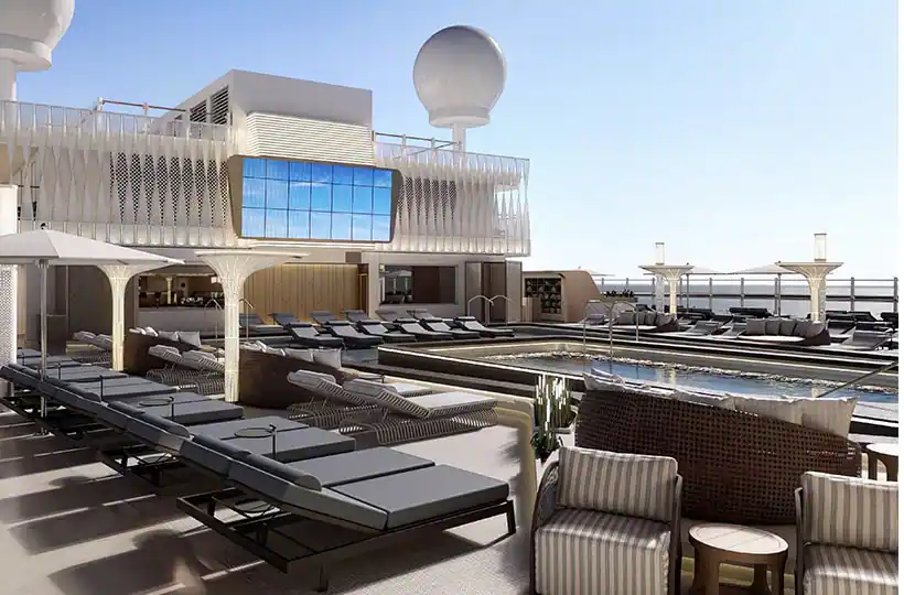 An outdoor pool deck during the day featuring many different seating areas.