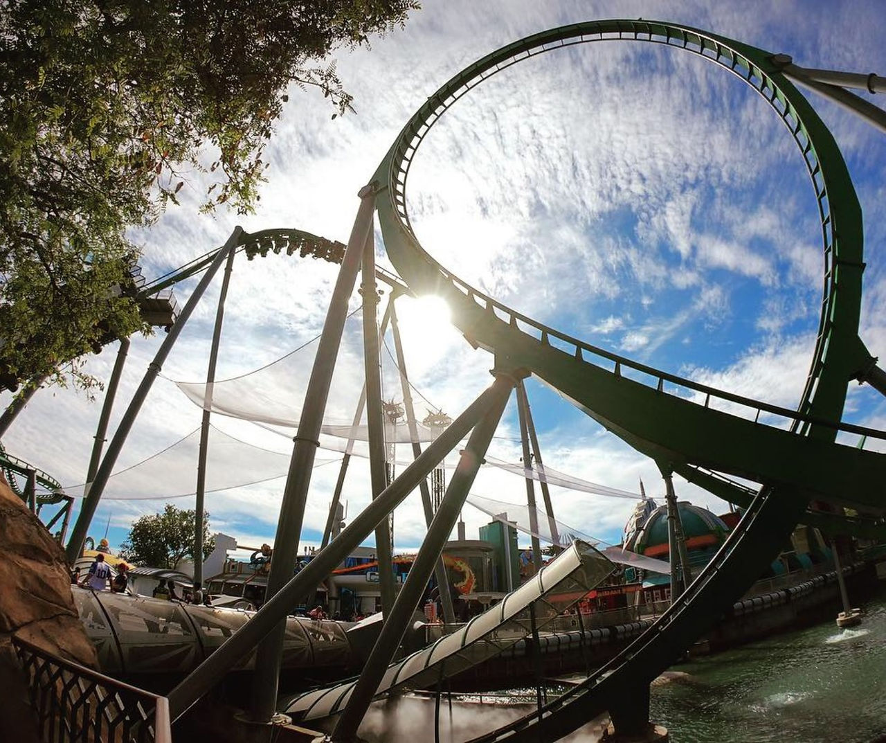 The Incredible Hulk Coaster at Universal Islands of Adventure with the sun shining in the background.