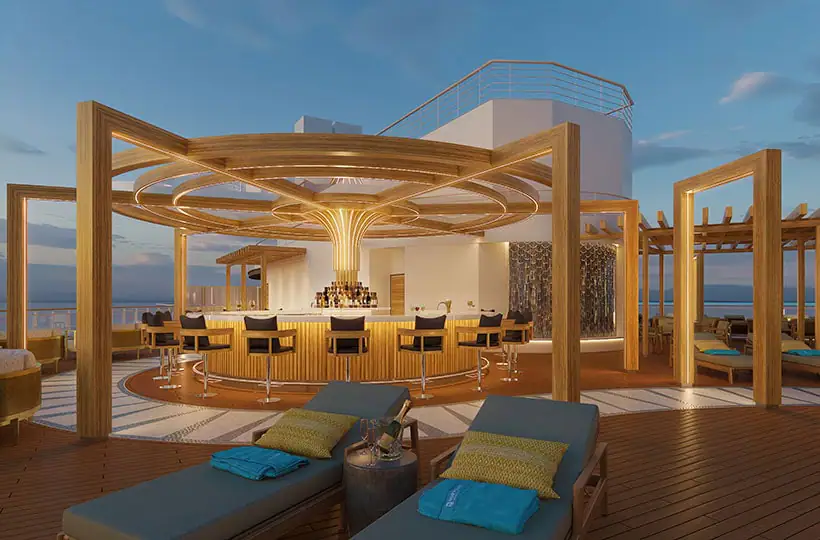 An open air bar with golden arches with couch seating to the side.