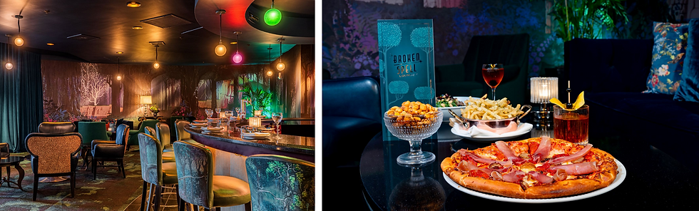 Cozy lounge with forest-themed decor, colorful lighting, and a bar setup. Pizza, fries, and drinks are on a table, with "Broken Spell Lounge" text.