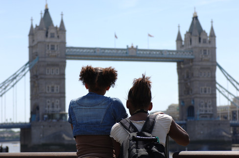 Two girls looking at the Tower of London Bridge.