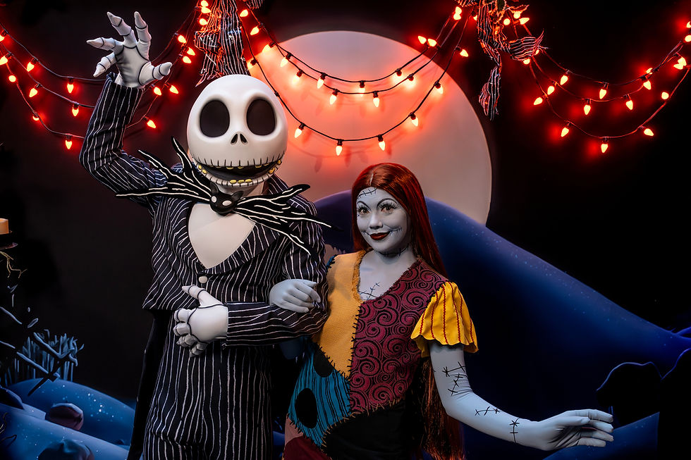 Jack Skellington and Sally pose under glowing red Halloween lights in a spooky Nightmare Before Christmas scene
