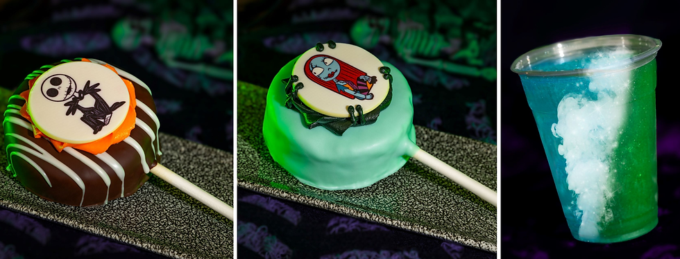 Halloween-themed treats: two decorated chocolate pops with character designs and a vibrant blue-green drink in a clear cup against a dark backdrop.