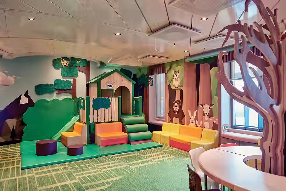 A play area for small kids. There are woodland creatures and trees on the walls.