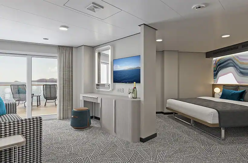 A room with a bed, couch, mirror, and TV. The room is decorated in black, white, and teal.