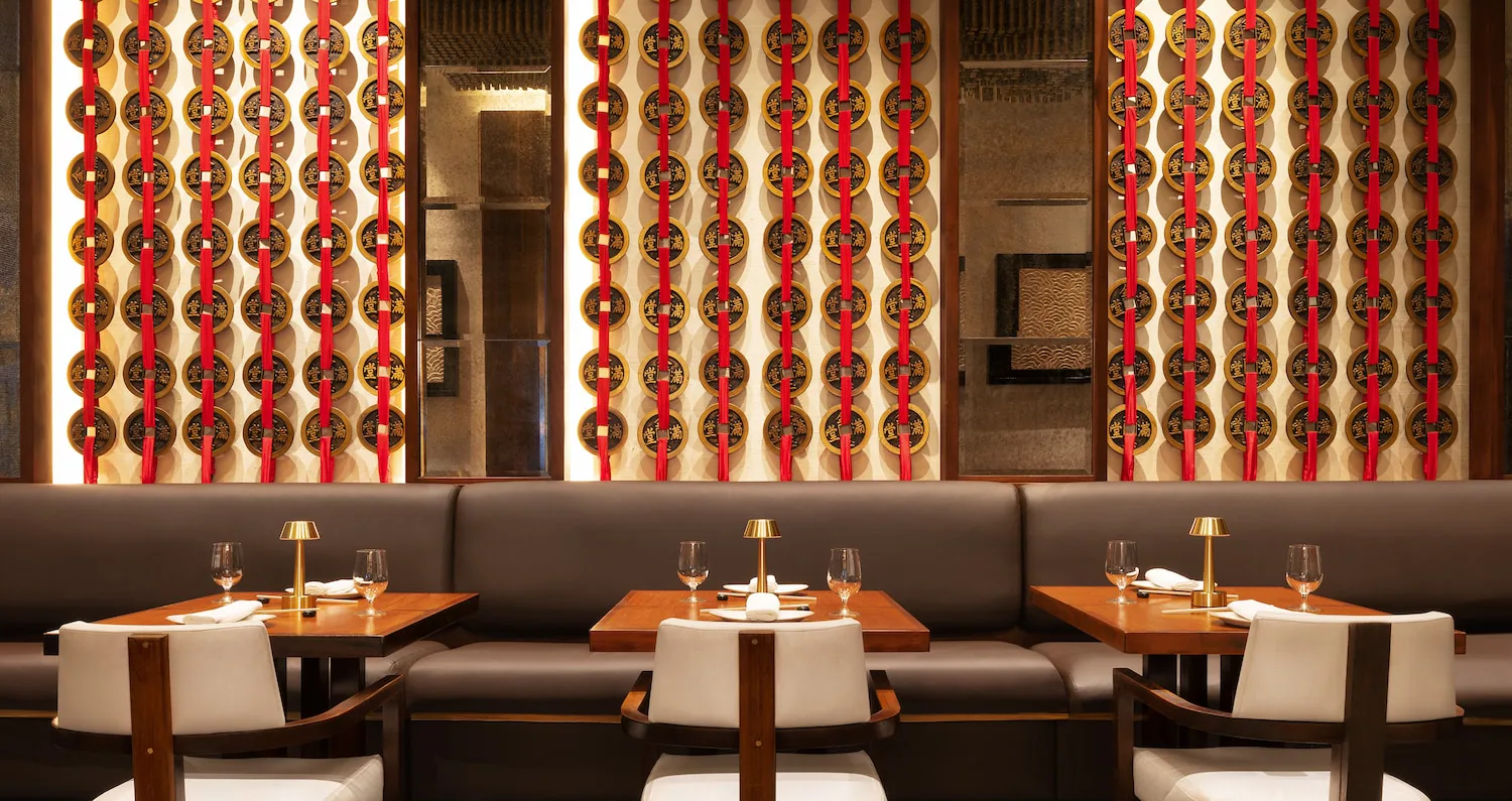 A restaurant table and chairs with Asian inspired decor.