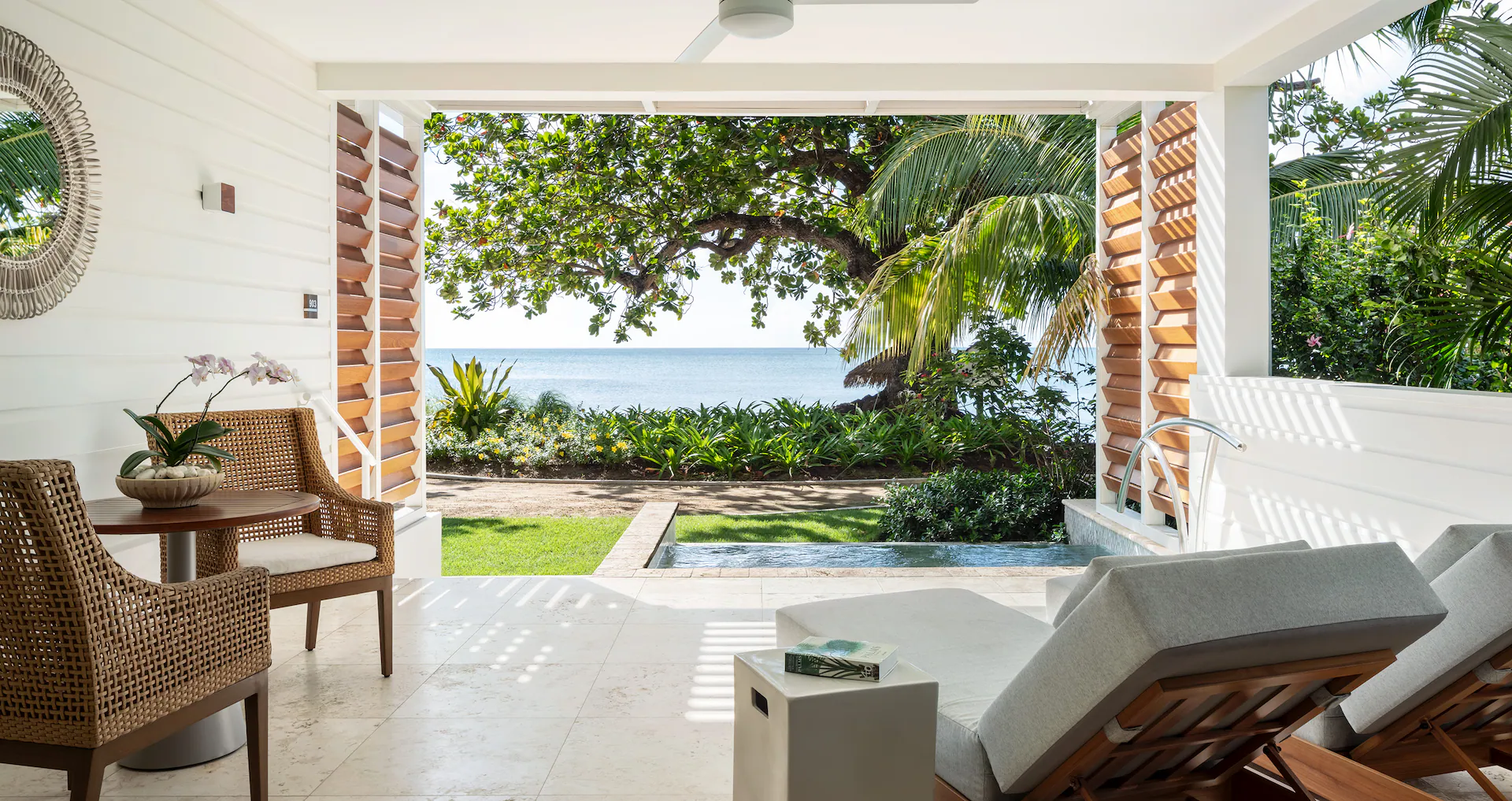 A look through the back of a resort room that over looks the ocean.