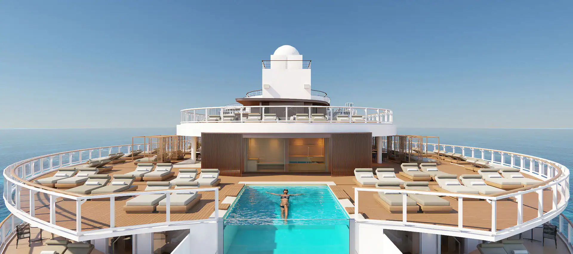 An arial view of a pool and seating. The sky is blue.