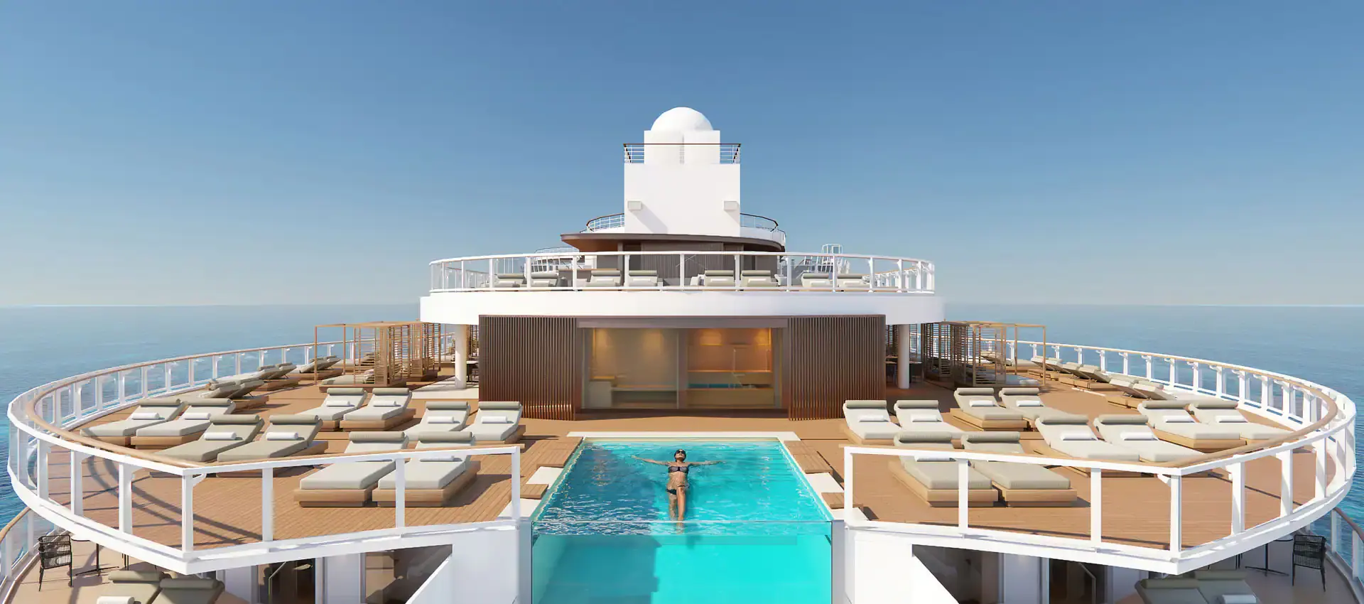 An arial view of a pool and seating. The sky is blue.