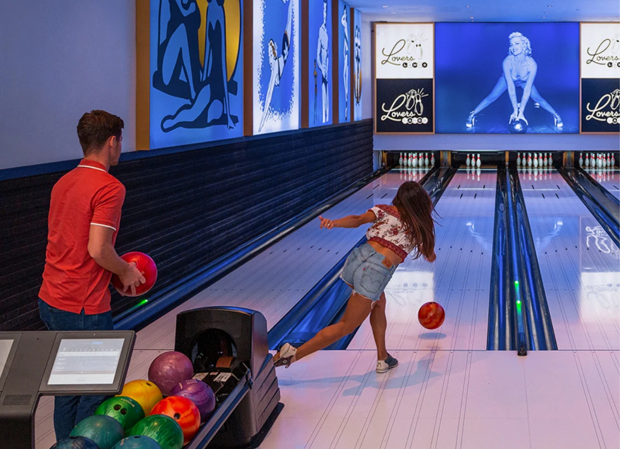 A boy and girl are bowling.
