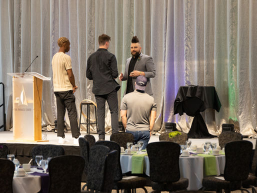 Trino in stage meeting with AV team before company event.