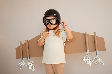 front-view-girl-playing-with-cardboard-wings.jpg