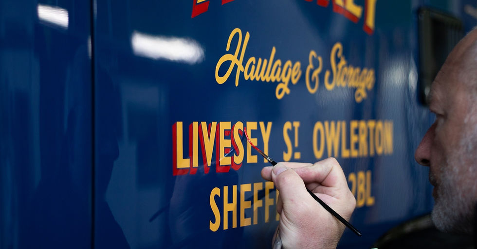 Traditional sign writing being painted onto a truck