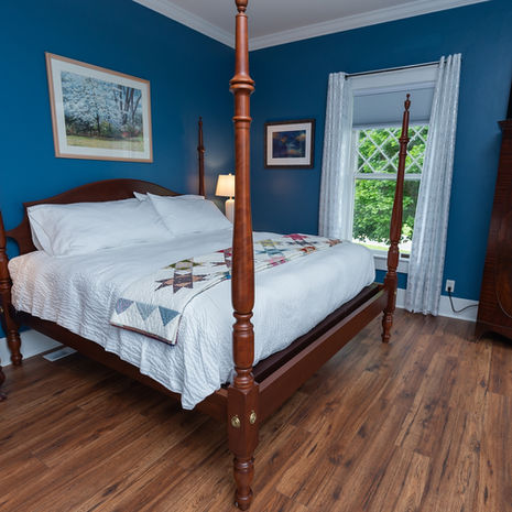 a blue painted room with beautiful king size bed