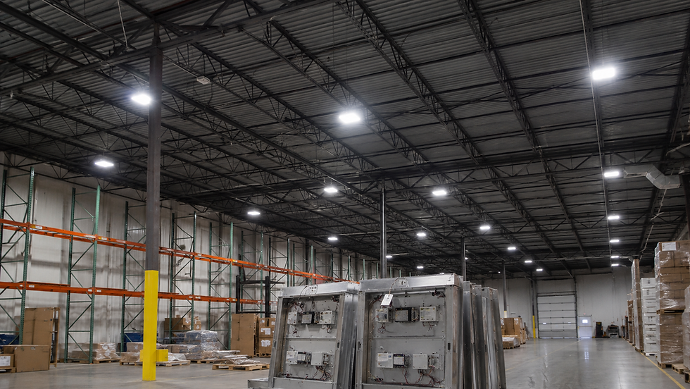 LED high-bay fixtures illuminating a large commercial distribution warehouse.