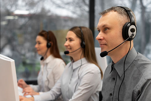 colleagues-working-together-call-center-with-headphones.jpg