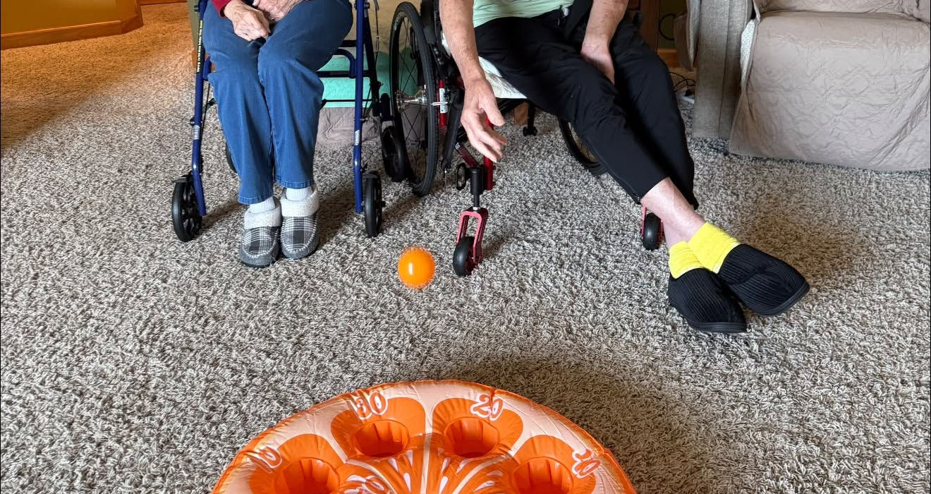 Residents enjoying an indoor bowling activity together.